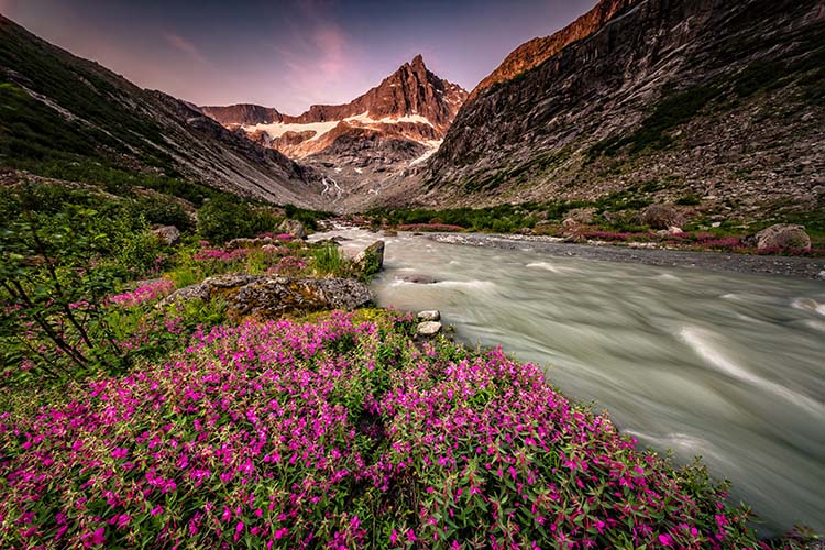 Picturesque Mountains of Alaska in summer. Snow covered massifs, glaciers and rocky peaks. Beautiful natural background.
